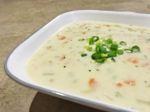 Fill your bowl with New England Clam Chowder. Packed with clams and vegetables, this take on a creamy northeastern classic keeps you warm and full! | Tiny Kitchen Cuisine | http://tiny.kitchen