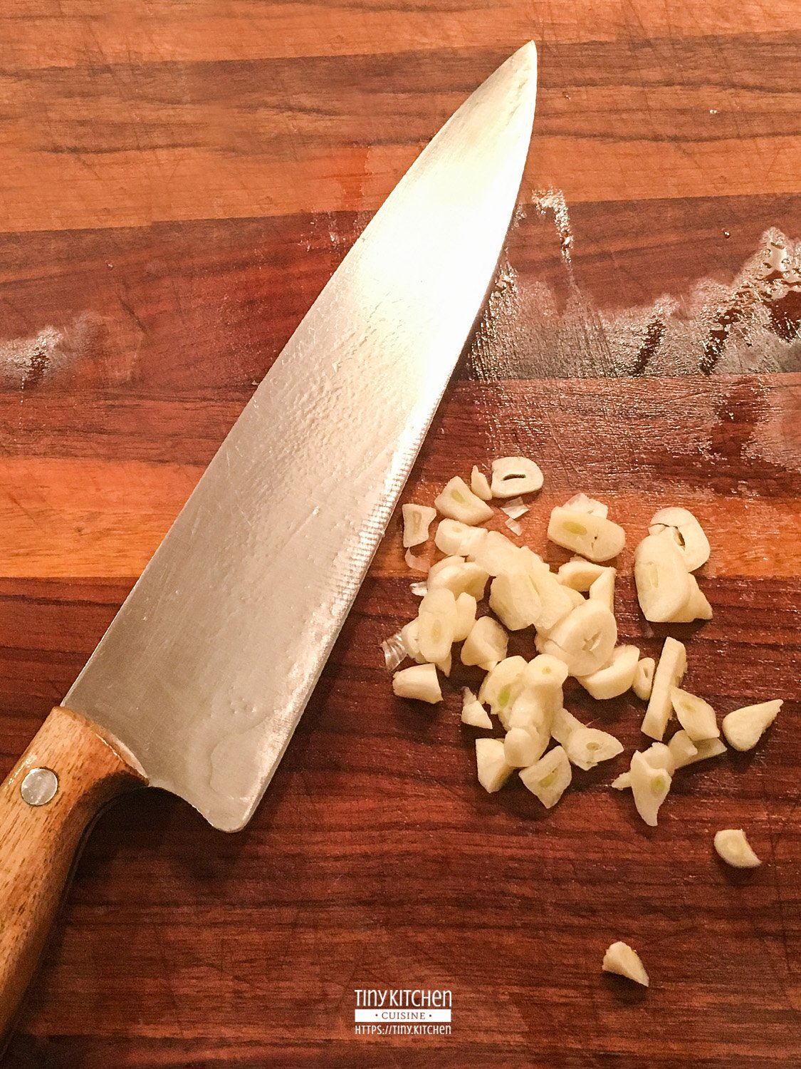 Chopped Garlic on a Dark Wooden Cutting Board | Tiny Kitchen Cuisine | https://tiny.kitchen