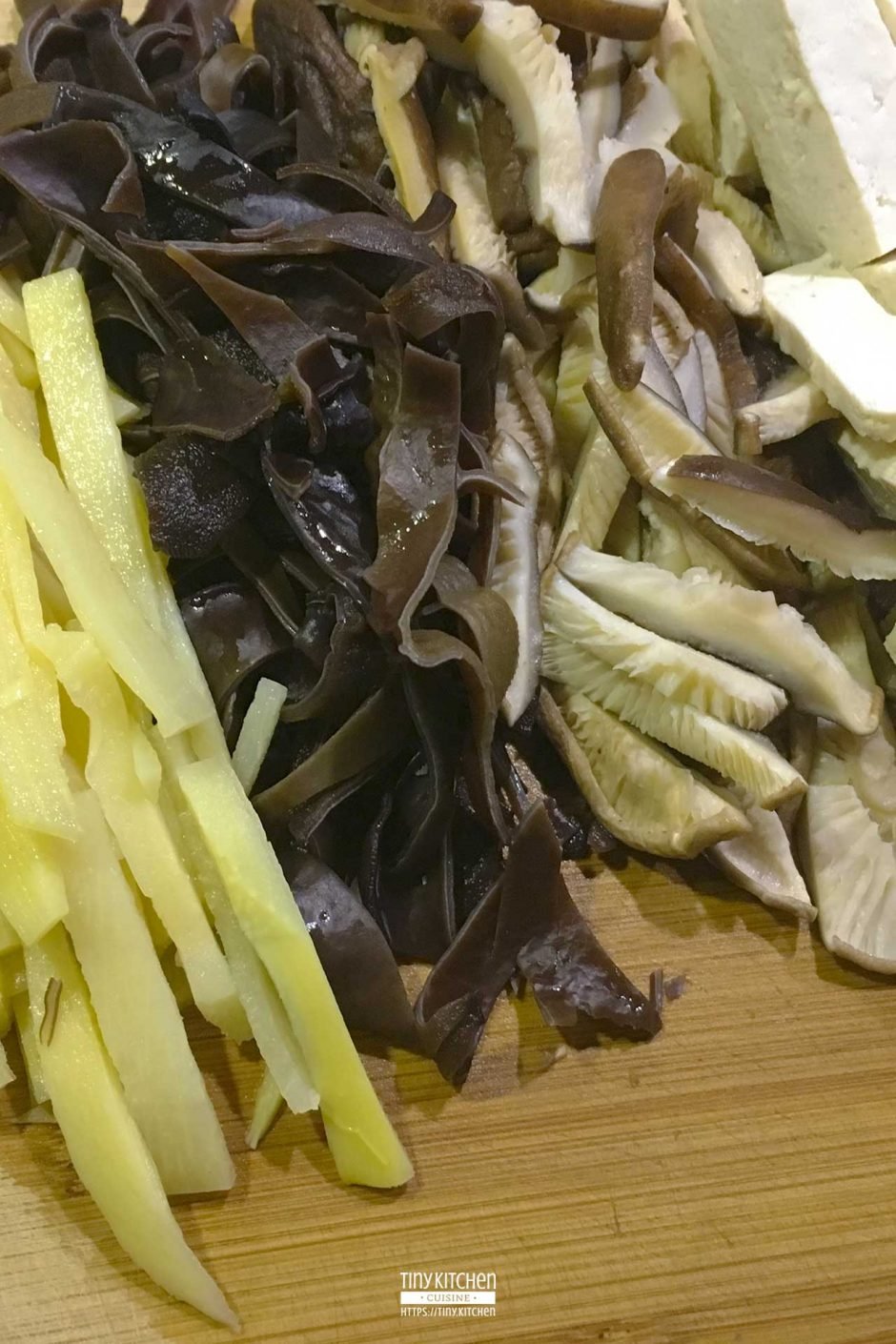 Bamboo shoots, wood ear mushrooms, shiitake mushrooms, and tofu sliced and prepared for Hot and Sour Soup.